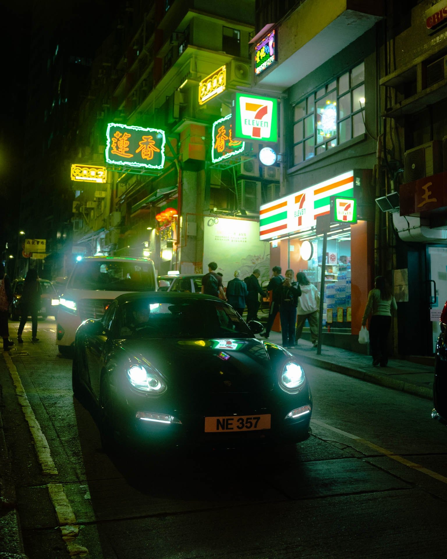 Porsche with the background of neon street signs in Mid-Levels, Hong-Kong